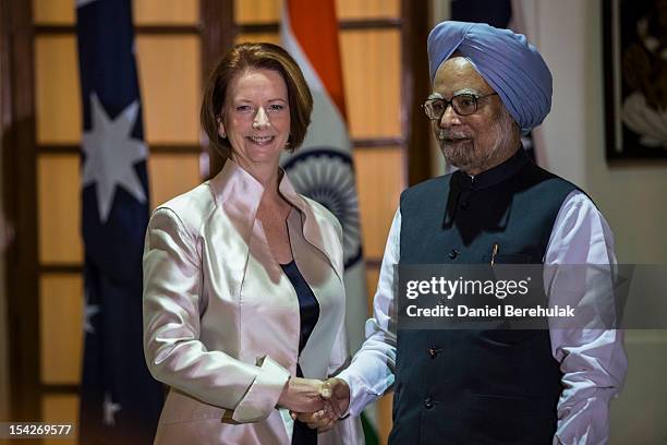 Australian Prime Minister Julia Gillard shakes hands with Indian Prime Minister Manmohan Singh prior to delegation level talks at Hyderabad House on...