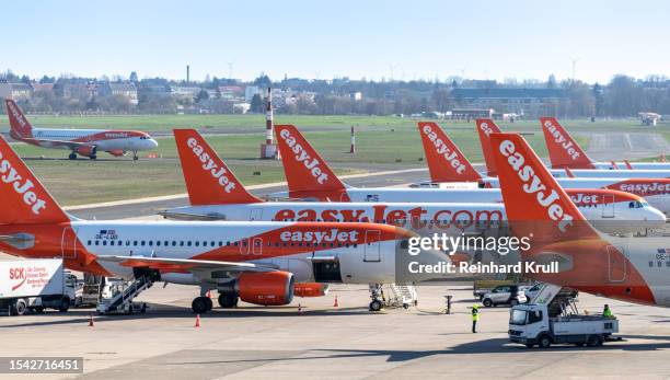 many easyjet airplanes at airport at parking position - easyjet stock pictures, royalty-free photos & images