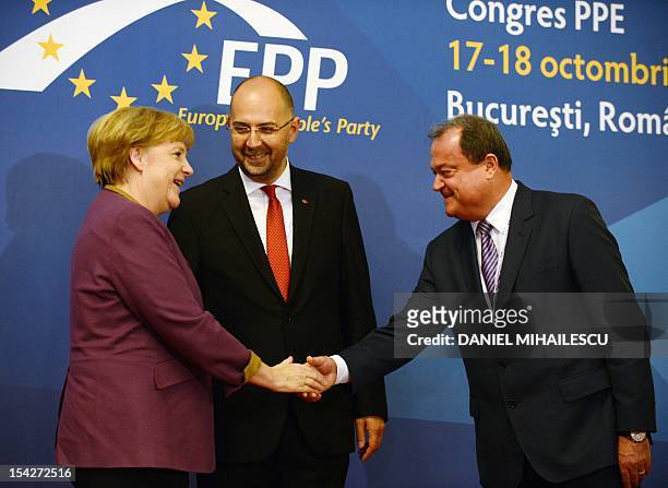 German Chancellor Angela Merkel is welcomed by Romanian Democratic Party President Vasile Blaga and Kelemen Hunor , the President of Democratic Union...