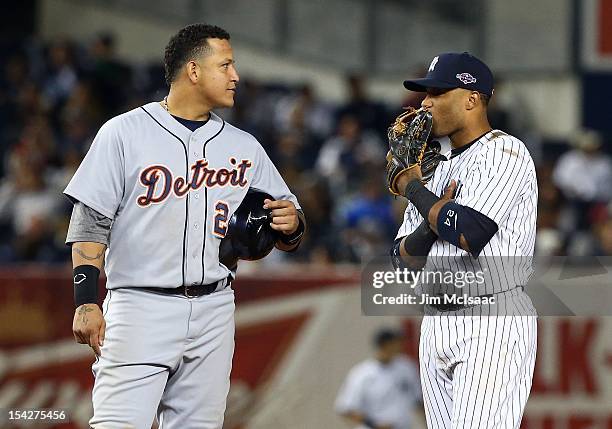 Miguel Cabrera of the Detroit Tigers talks with Robinson Cano of the New York Yankees during Game Two of the American League Championship Series at...