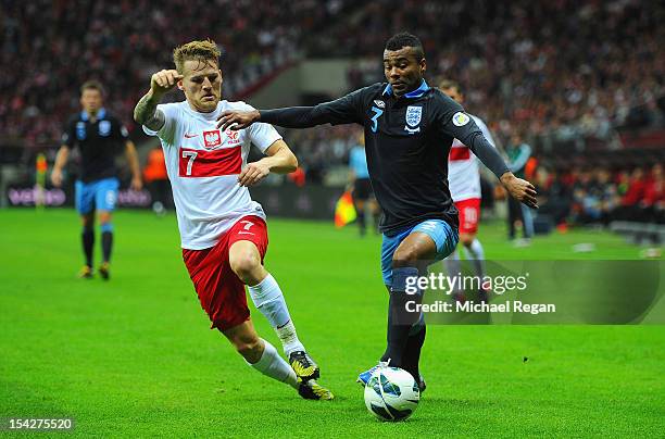 Ashley Cole of England in action with Eugen Polanski of Poland during the FIFA 2014 World Cup Qualifier between Poland and England at the National...