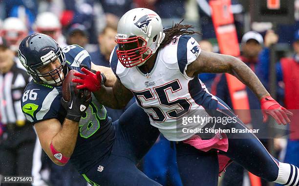 Zach Miller of the Seattle Seahawks pulls down a catch in front of Brandon Spikes of the New England Patriots during a game at CenturyLink Field on...