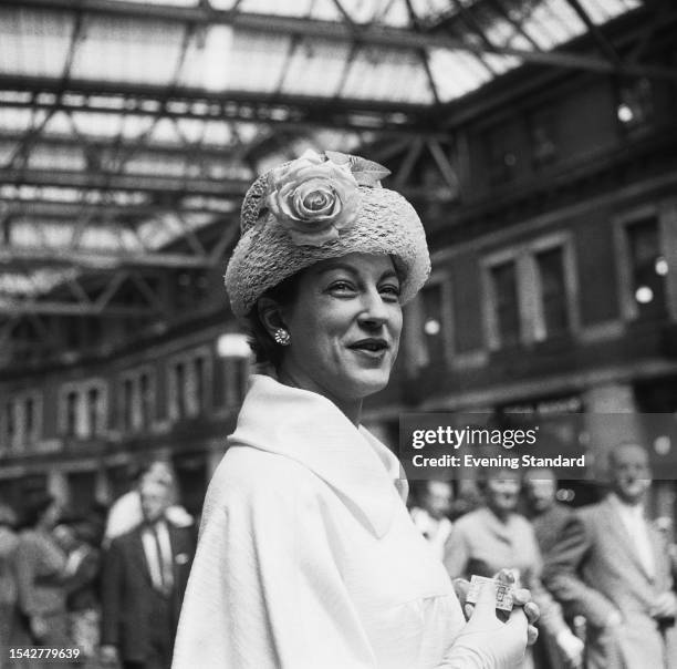 The Begum Jahanara of Palanpur wearing a hat embellished with a rose at Waterloo Station in London, June 18th 1959.