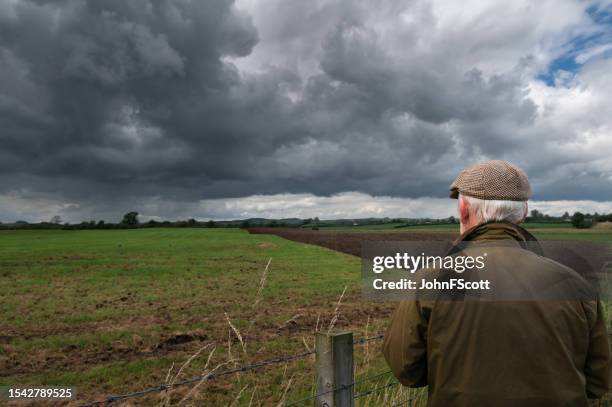 senior man looking at a plowed field - waxed jacket stock pictures, royalty-free photos & images