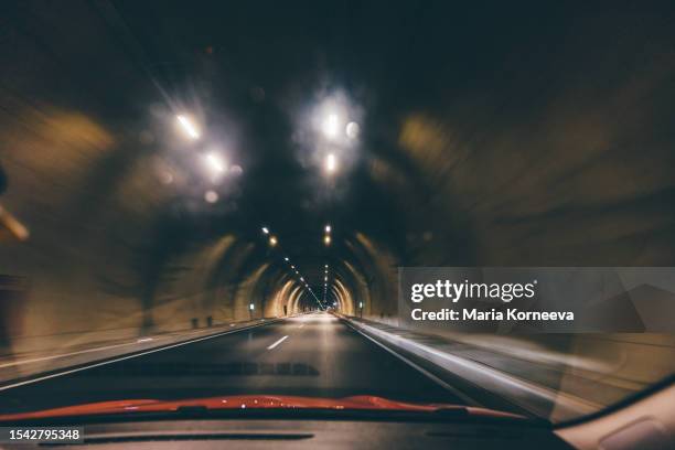 illuminated tunnel seen through car windshield - car point of view stock pictures, royalty-free photos & images