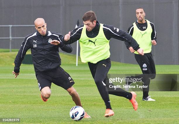 Gabriel Obertan and Davide Santon compete for a ball during a Newcastle United training session at The Little Benton training ground on October 17,...