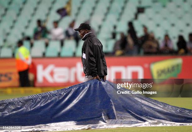 Covers are laid on the pitch after rain stopped play during the Karbonn Smart CLT20 match between Kolkata Knight Riders and Perth Scorchers at Sahara...