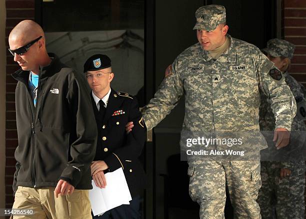 Army Pfc. Bradley Manning is escorted away after a hearing on the witness list of a speedy trial motion October 17, 2012 at Fort Meade in Maryland....