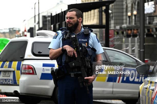 Police officer cordons off an area near the site of a shooting in central Auckland on July 20, 2023. New Zealand Prime Minister Chris Hipkins said a...