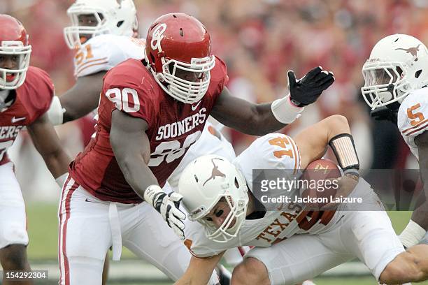 Defensive end David King of the Oklahoma Sooners sacks quarterback David Ash of the Texas Longhorns on October 13, 2012 at The Cotton Bowl in Dallas,...