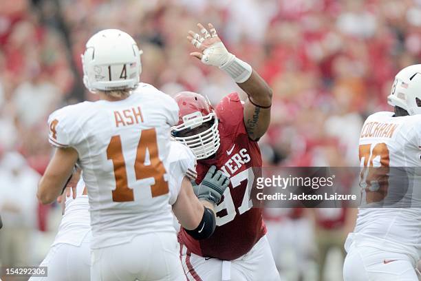 Defensive tackle Jamarkus McFarland of the Oklahoma Sooners pressures quarterback David Ash of the Texas Longhorns on October 13, 2012 at The Cotton...