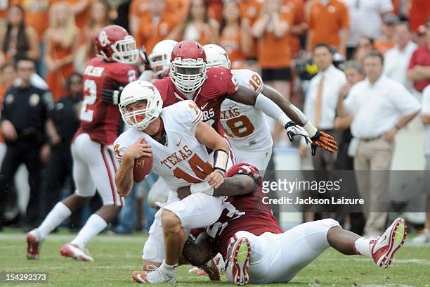 Defensive tackle Casey Walker of the Oklahoma Sooners sacks quarterback David Ash of the Texas Longhorns on October 13, 2012 at The Cotton Bowl in...