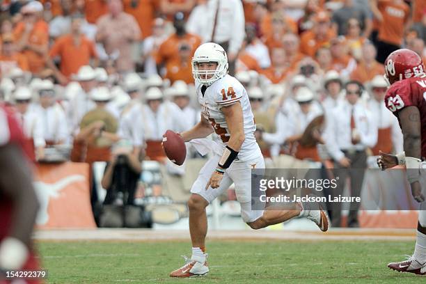 Quarterback David Ash of the Texas Longhorns scrambles out of the pocket during their game against the Oklahoma Sooners on October 13, 2012 at The...