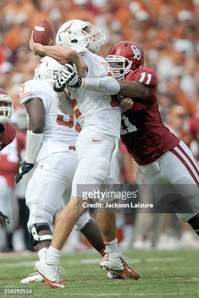 Defensive end R.J. Washington of the Oklahoma Sooners hits quarterback David Ash of the Texas Longhorns on October 13, 2012 at The Cotton Bowl in...
