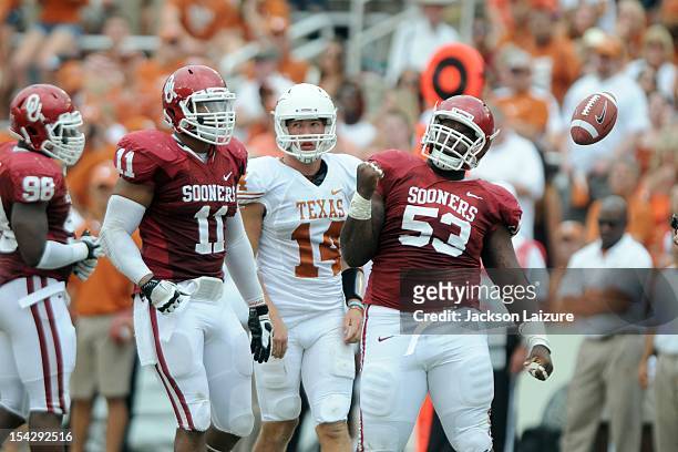 Defensive tackle Casey Walker and defensive end R.J. Washington of the Oklahoma Sooners react after sacking quarterback David Ash of the Texas...