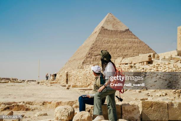 multiracial couple working on their laptops in giza area, pyramid pharaoh, cairo - egypt tourist stock pictures, royalty-free photos & images