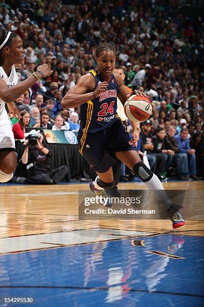 Tamika Catchings of the Indiana Fever dribbles the ball against Taj McWilliams-Franklin of the Minnesota Lynx during the 2012 WNBA Finals Game Two on...