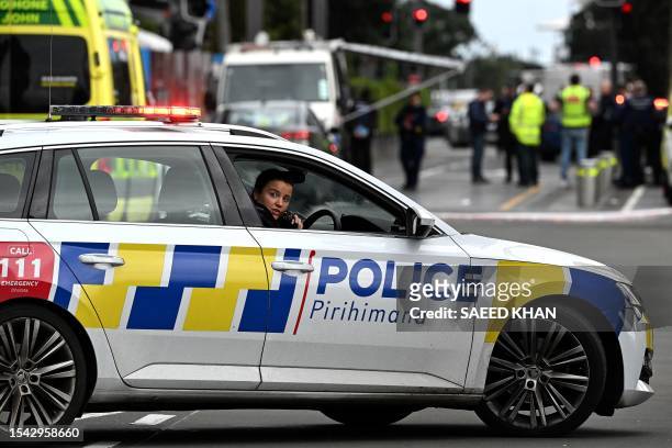 Police officers cordon off an area near the site of a shooting in central Auckland on July 20, 2023. New Zealand Prime Minister Chris Hipkins said a...