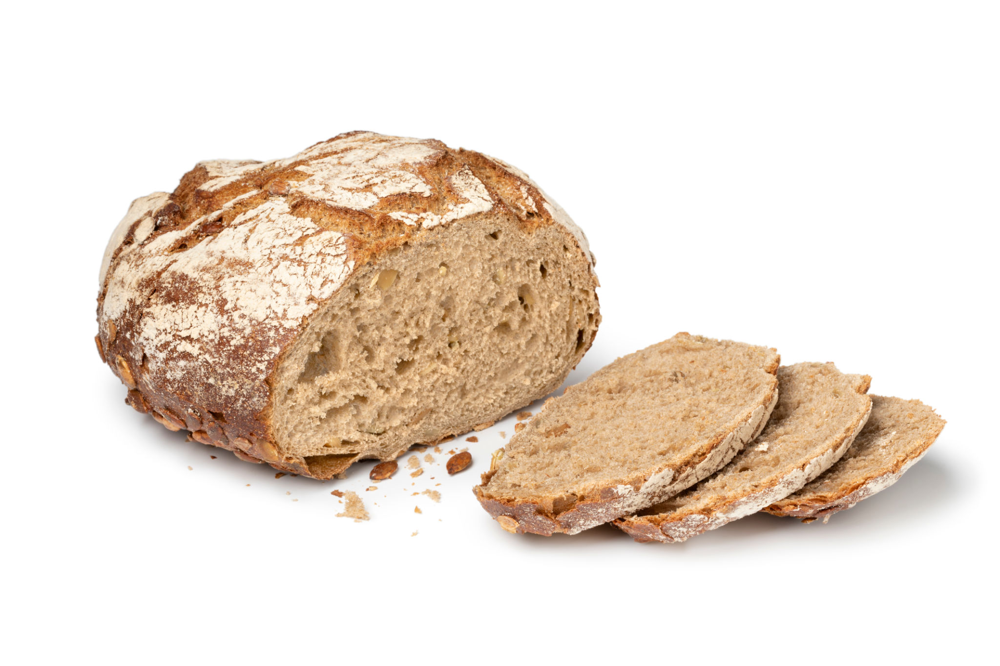 Sourdough loaf of bread with pumpkin seeds and slices close up on white background Sourdough loaf of bread with pumpkin seeds and slices close up on white background