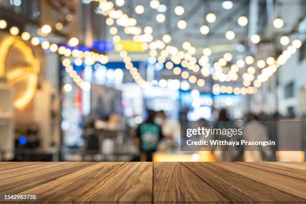 empty wooden table top with blur coffee shop or restaurant interior background - blurred motion restaurant stock pictures, royalty-free photos & images