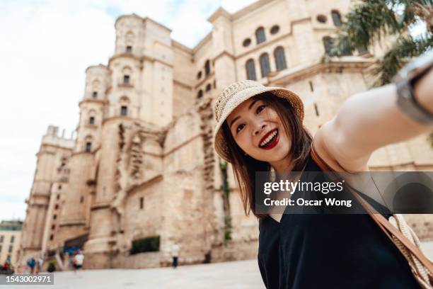 personal perspective of young asian woman taking selfie with camera while travelling - center for asian american media stock pictures, royalty-free photos & images