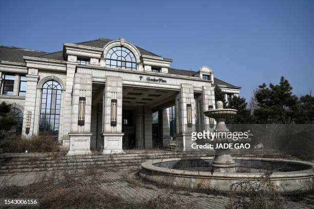 This photo taken on March 31, 2023 shows the exterior of a deserted housing sales building in a suburb of Shenyang in China's northeastern Liaoning...
