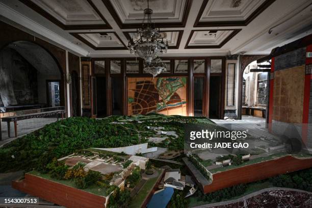 This photo taken on March 31, 2023 shows a housing estate model at a deserted housing sales building in a suburb of Shenyang in China's northeastern...