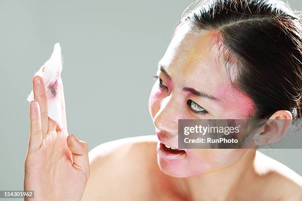 woman removing makeup with a cotton - removing make up stock pictures, royalty-free photos & images