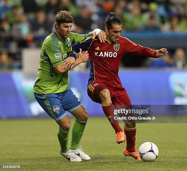 Fabian Esp’ndola of Real Salt Lake dribbles against Jeff Parke of the Seattle Sounders FC at CenturyLink Field on October 17, 2012 in Seattle,...