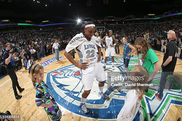 Monica Wright and Candice Wiggins of the Minnesota Lynx celebrate with fans after the 2012 WNBA Finals Game Two win over the Indiana Fever on October...