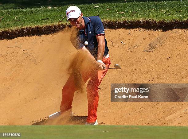 Andrew Tschudin of Australia plays out of a bunker during round one of the Perth International at Lake Karrinyup Country Club on October 18, 2012 in...