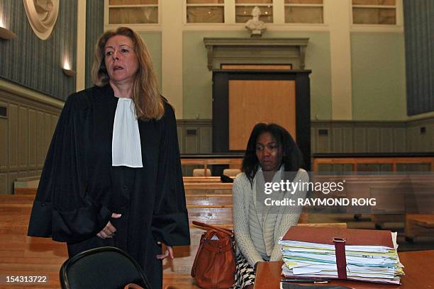 Diane Mistler , a Madagascan woman who allegedly tricked one of her many lovers into killing her husband with a fishing harpoon waits next to her...