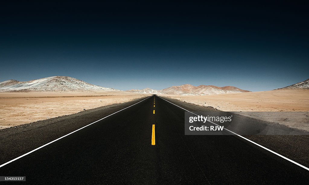 Endless Straight Road through Desert Mountains