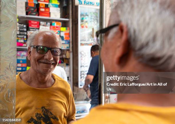 Smiling indian man choosing eyeglasses in an optics, Delhi, New Delhi, India on June 20, 2023 in New Delhi, India.