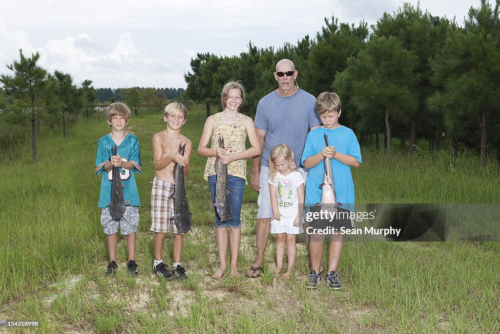 Group of People Holding Caught Fish