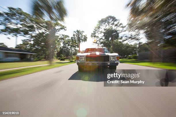 1970's car driving on a street - zoom effect - fotografias e filmes do acervo