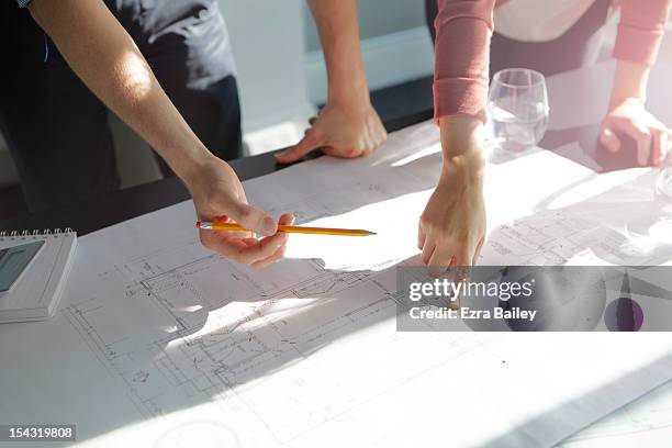 two business people discussing plans. - architects design drawings stockfoto's en -beelden