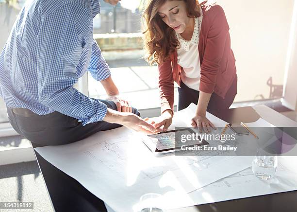 business people discussing plans on tablet. - architect stock pictures, royalty-free photos & images