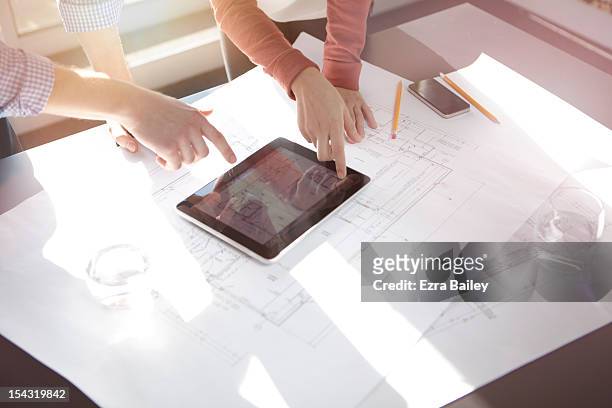 business people discussing plans on tablet. - progettare foto e immagini stock