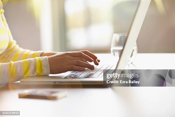 woman typing on her laptop. - notebook stockfoto's en -beelden