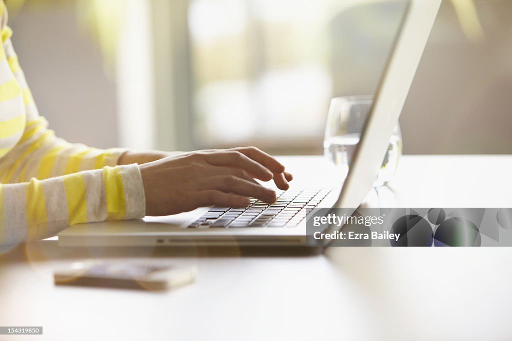 Woman typing on her laptop.