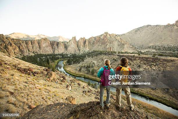 a man and woman hiking. - smith rock state park stock-fotos und bilder