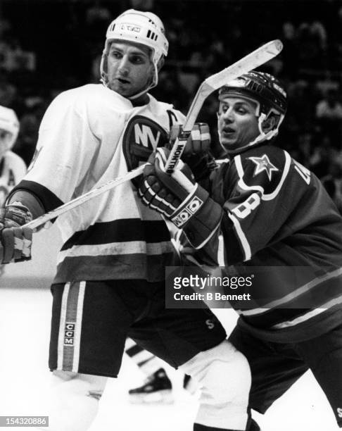Igor Larionov of CSKA Moscow battles with Brent Sutter of the New York Islanders during their game on December 29, 1988 at the Nassau Coliseum in...