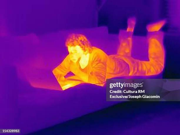 thermal view of man using laptop - infrared stockfoto's en -beelden