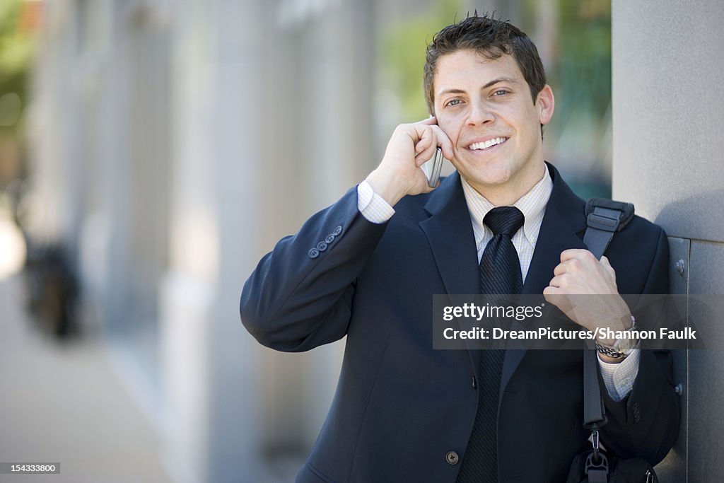 Businessman on cell phone outside