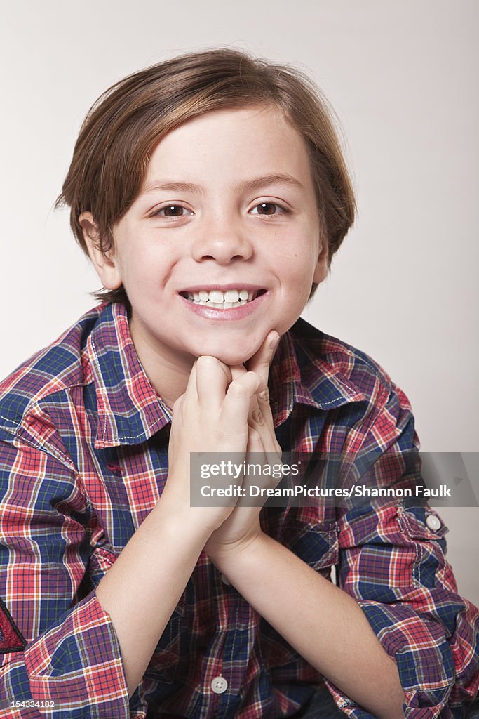 Studio portrait of smiling boy (8-9)