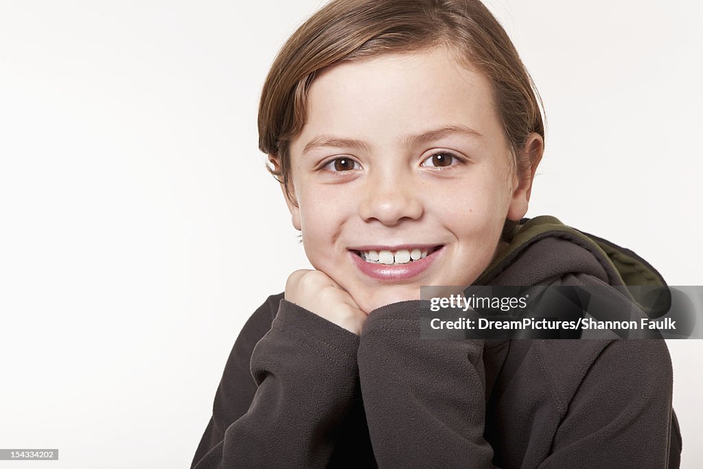 Studio portrait of smiling boy (8-9)