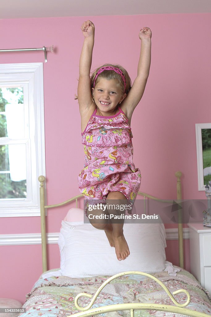 Girl jumping on the bed