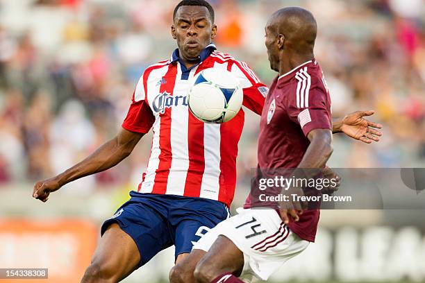 Juan Pablo Angel of Chivas USA and Omar Cummings of the Colorado Rapids battle for possession of the ball during their MLS match at Dick's Sporting...