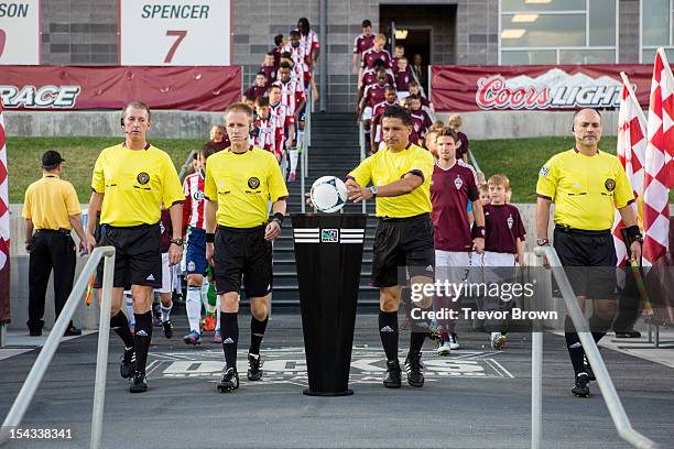 Referee Ramon Hernandez picks up the game ball before the start of the MLS match between the Colorado Rapids and Chivas USA at Dick's Sporting Goods...